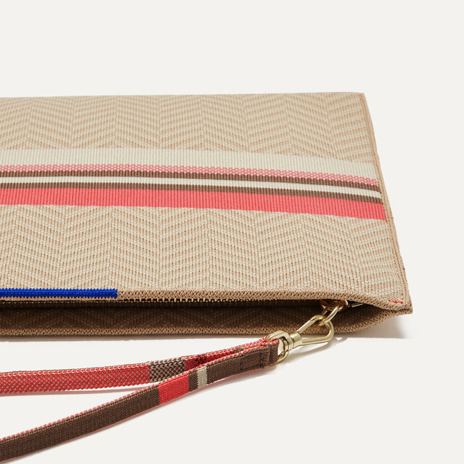 Close up of the zipper closure and wrist strap of The Wristlet in Sunkissed.