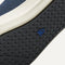 Close up of the outsoles of The RS02 Sneaker in Navy, with raised grooves for added traction.