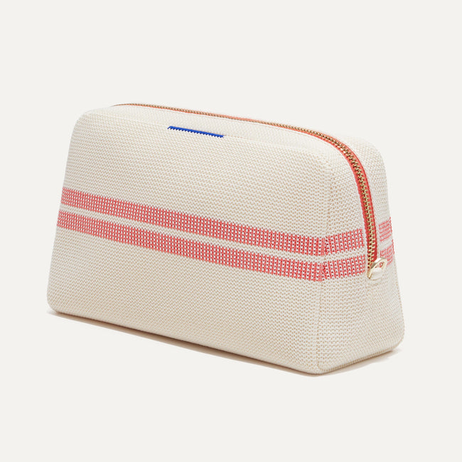 The Universal Pouch in Coral Stripe shown at a diagonal view from the right.