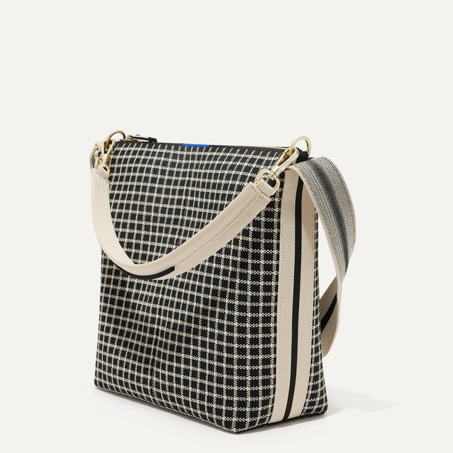 The Mini Zip Bucket in Black & Ivory Grid shown at a diagonal view from the left.