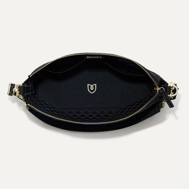 The Daily Crossbody Bag in Black Sand shown from the top down, with zipper open and interior exposed.