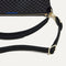 A closeup of The Daily Crossbody Bag in Black Sand, showing the smooth zipper closure and soft, flexible handle.