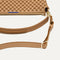 A closeup of The Daily Crossbody Bag in Hazelnut, showing the smooth zipper closure and soft, flexible handle.