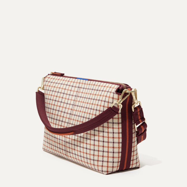 The Daily Crossbody Bag in Malbec Grid shown at a diagonal view from the left.