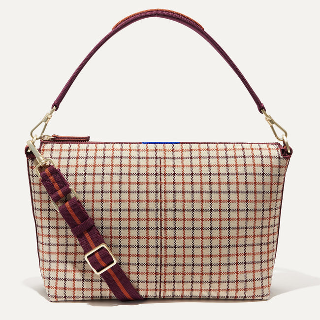 The Daily Crossbody Bag in Malbec Grid shown from the front.