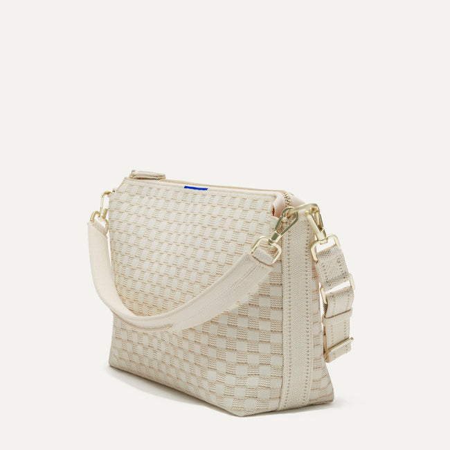 The Daily Crossbody Bag in White Sand shown at a diagonal view from the left.