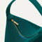 A closeup of The Party Pouch in Emerald Green, focusing on the zipper and magnet closure.