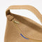 A closeup of The Party Pouch in Goldstone, focusing on the zipper and magnet closure.