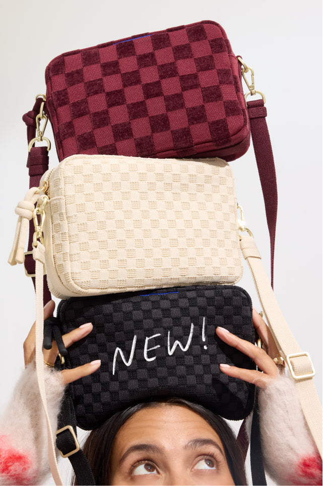 Model holding The Crossbody Camera Bag in Black Sand, Sesame, ReVelvet™ Cab. 