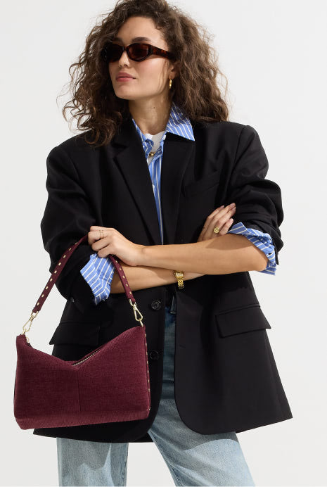 Model holding The ReVelvet™ Daily Crossbody in ReVelvet™ Syrah.
