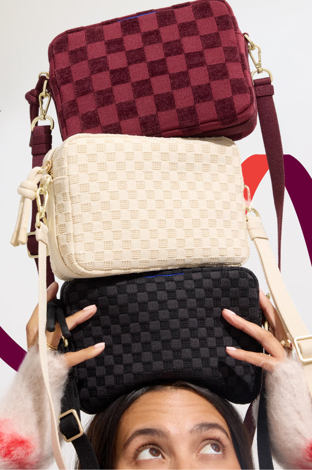 Model holding The Crossbody Camera Bag in Black Sand, Sesame, ReVelvet™ Cab. 