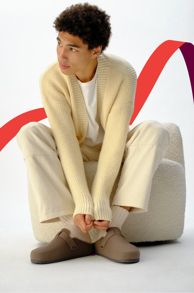 Man sitting wearing the men's clog.