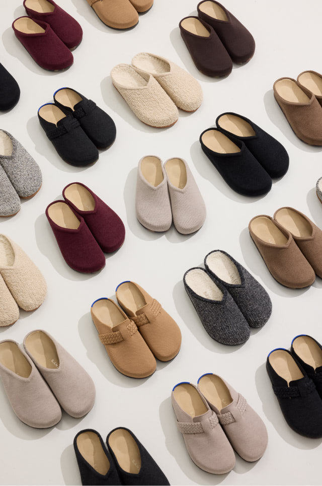 Various pairs of The Casual Clog in different colors arranged on a light background