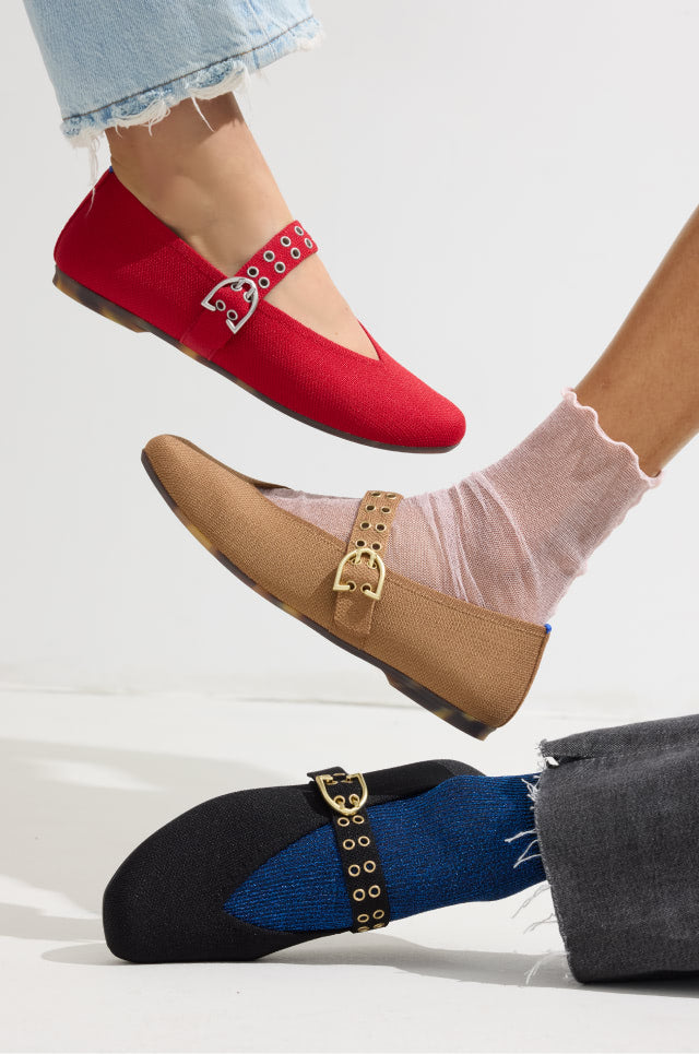 Three pairs of The Max Buckle Mary Jane in red, brown, and black with decorative elements on a light background.