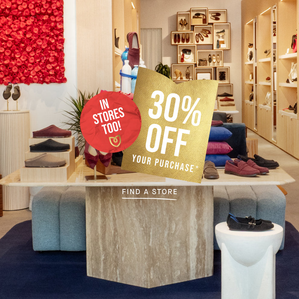Promotional sign for 30% off in a store setting with shoes and decor.