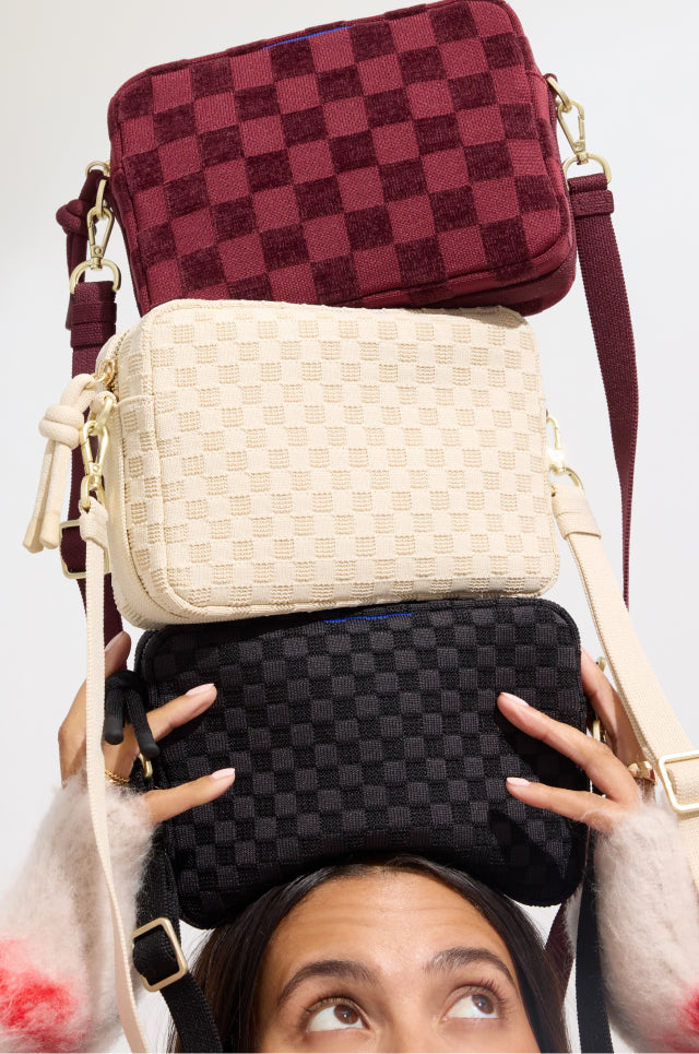 Model holding The Crossbody Camera Bag in Black Sand, Sesame, ReVelvet™ Cab. 