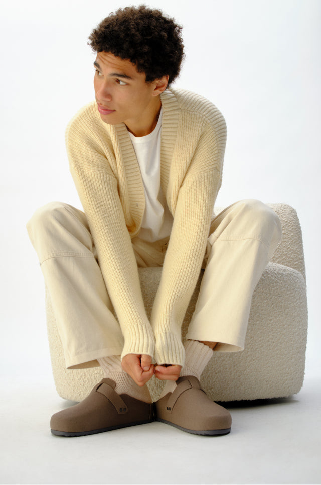 Man sitting wearing the men's clog.