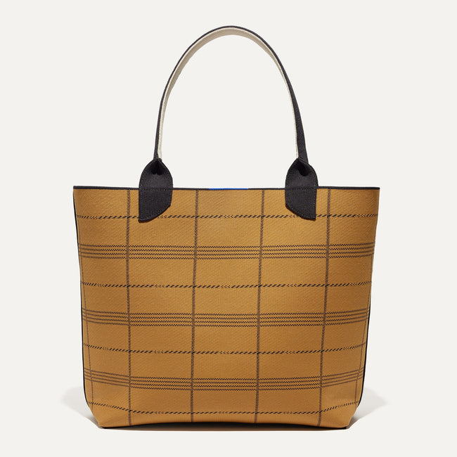 The Reversible Lightweight Tote in Black Glen Plaid shown from the front with the reverse side showing.