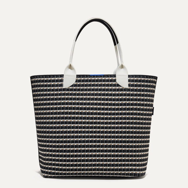 The reversible side of The Lightweight Tote in Black & White Checkers shown from the front. 