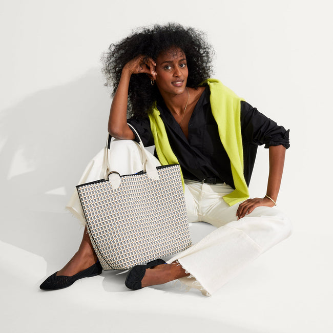 An alternate view of model holding The Lightweight Tote in Black & White Checkers.
