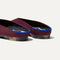 Close up of the heel of The Almond Demi in Black Cherry, with Rothy's signature blue halo. 