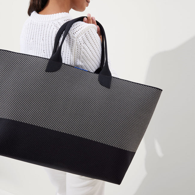 hover | The Lightweight Mega Tote in Grey Mist Twill, worn over the shoulder by a model, shown from the side. 