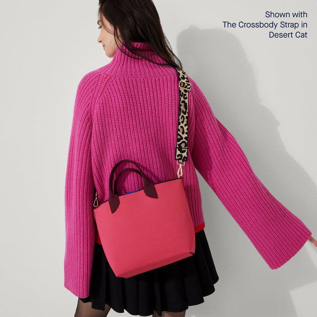The Lightweight Petite Tote in Perfect Pink, worn as a crossbody by a model, shown from the front.