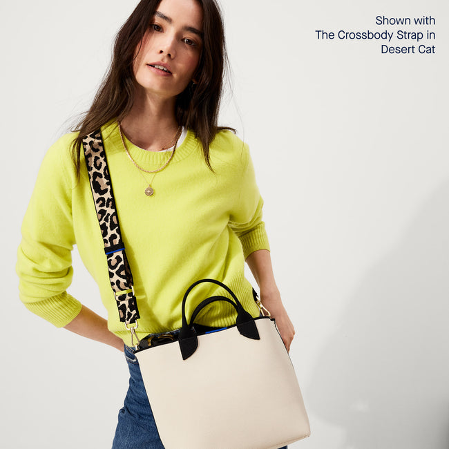 The Lightweight Petite Tote in Vanilla Cream, worn as a crossbody by a model, shown from the front.