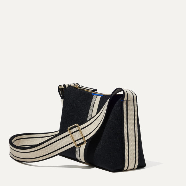 The Casual Crossbody in Black & Ivory Stripe, shown from the side at an angle.