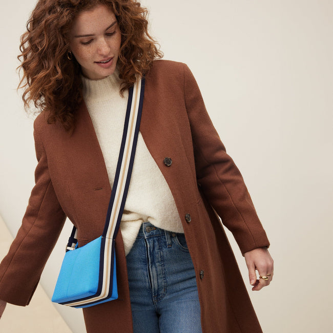 The Casual Crossbody in Cerulean Sky, worn as a crossbody by a model, shown from the side. 