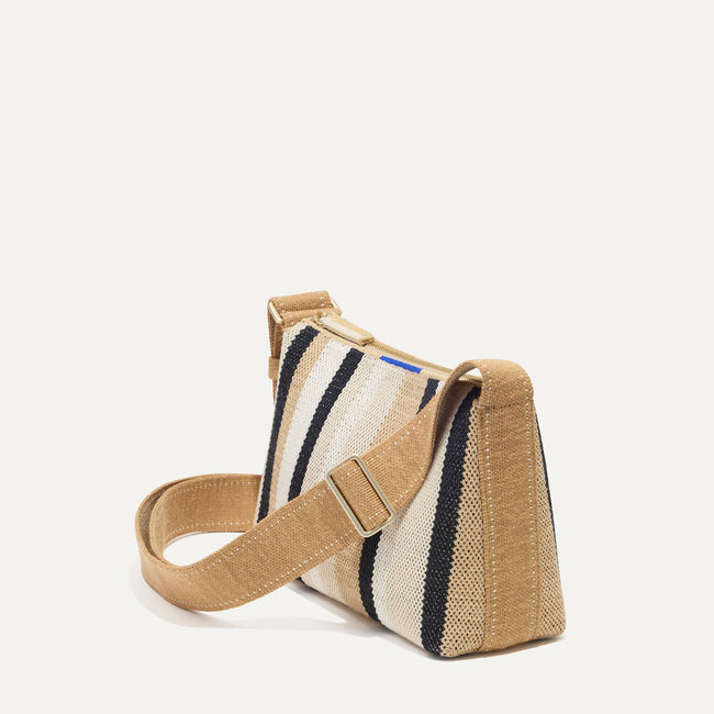The Casual Crossbody in Coco Stripe, shown from the side at an angle.