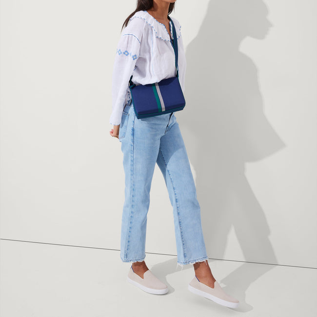 The Casual Crossbody in Ivy Stripe, worn as a crossbody by a model, shown from the side. 