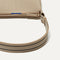 A closeup of The Casual Crossbody in Parchment, focusing on the crossbody strap. 