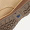 Close up of the outsoles of The Chukka Boot in Desert Sand, with raised grooves for added traction. 
