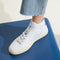 hover | Model wearing The High Top Sneaker in Bright White.