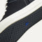 Outsole of The High Top Sneaker in hemp in Black shown from below, in diagonal view.