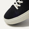 The toe and vamp of The High Top Sneaker in Hemp in Black, in diagonal view.