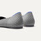 Close up of the heel of The Point II in Pebble Herringbone, with Rothy's signature blue halo. 