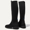 The Tall Lug Boot in Onyx Black shown from the back, in diagonal view.