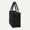 The Classic Tote in Black Sand, shown from the side.