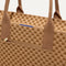 A closeup of The Classic Tote in Hazelnut, focusing on the exterior zip pocket. 