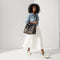 model | Overlay:: Shown with The Crossbody Strap (sold separately). | Alt:: Alternate view of a model wearing The RS02 Sneaker in Kelly.