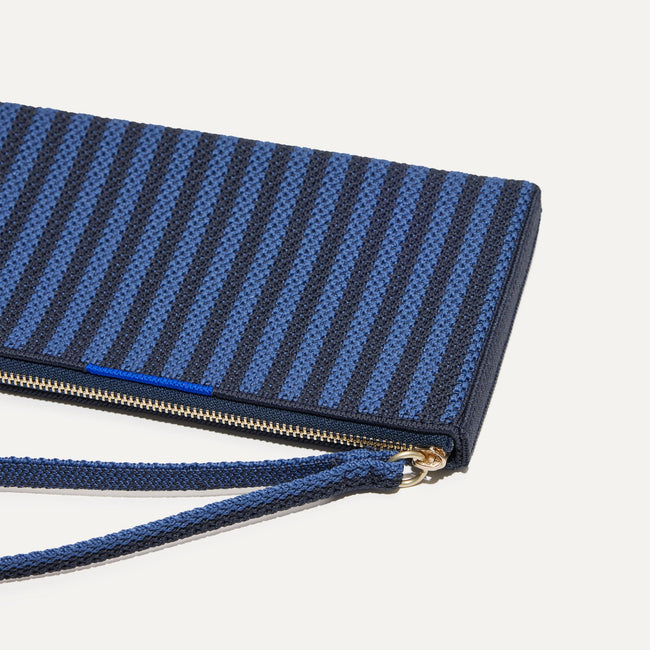 A closeup of The Wallet Wristlet in Navy Stripe, focusing on the wrist strap.