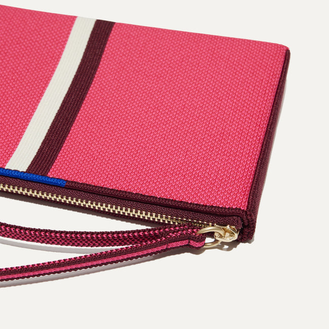A closeup of The Wallet Wristlet in Perfect Pink, focusing on the wrist strap.