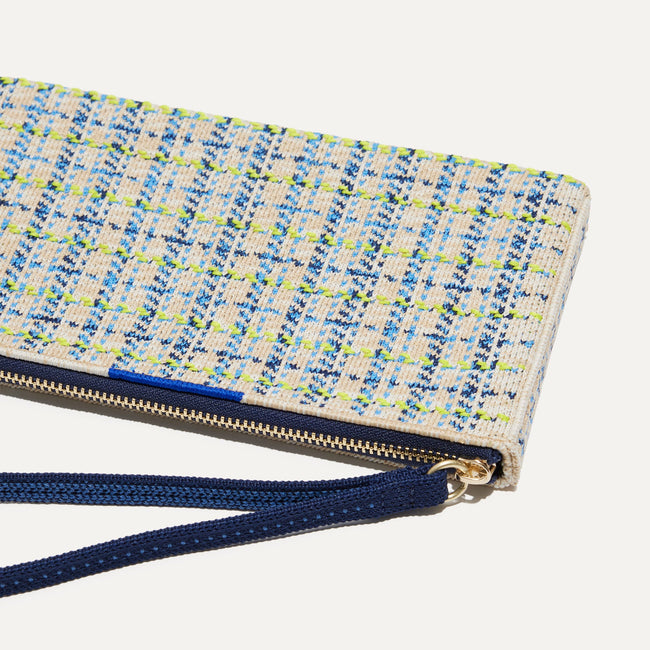 A closeup of The Wallet Wristlet in Spring Tweed, focusing on the wrist strap and zipper.