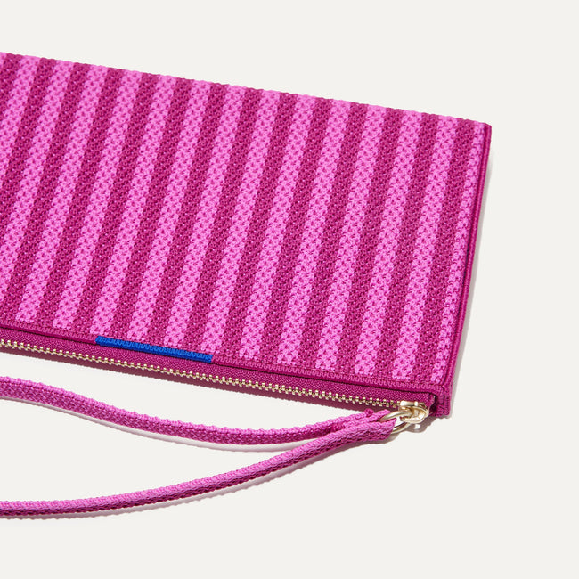 A closeup of The Wallet Wristlet in Tulip Pink Colorblock, focusing on the wrist strap.
