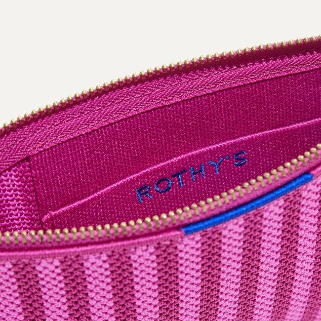 A closeup of The Wallet Wristlet in Tulip Pink Colorblock, focusing on the inner card slip.