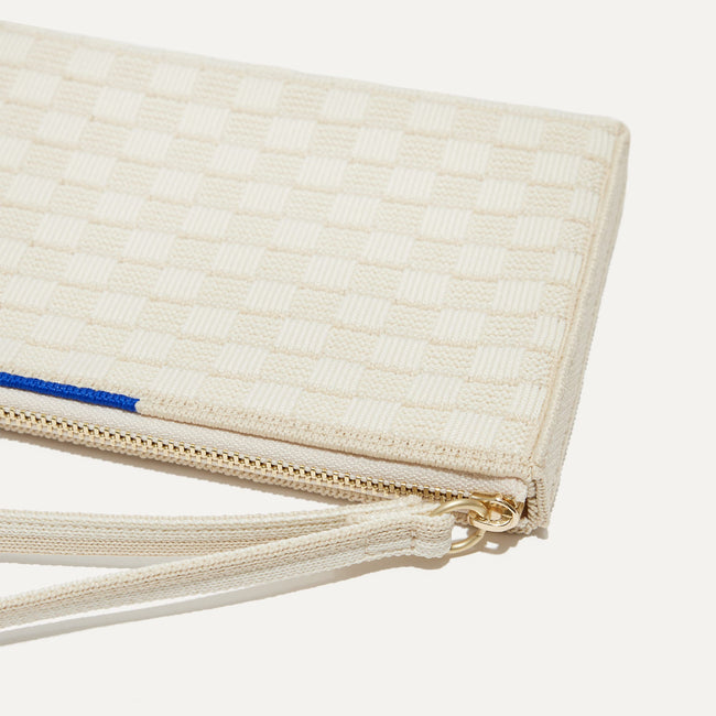 A closeup of The Wallet Wristlet in Vanilla Basketweave, focusing on the wrist strap.