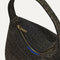 A close-up of the zipper detail and Rothy's blue halo on The Party Pouch in Onyx Sparkle.