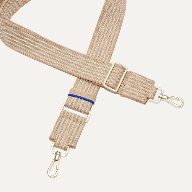A close-up of The Crossbody Strap in Brown Sugar, focusing on the end snap hooks and sliding buckle.